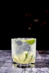 cocktail in a transparent glass with a starry black background