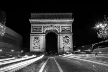 Fototapeta na wymiar Nightly traffic on the Champs-Elysees, Arc de Triomph in the background