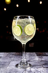 cocktail in a transparent glass with a starry black background
