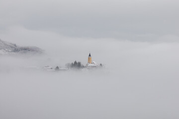 Winter in Croatia. Church. Fog. Snow