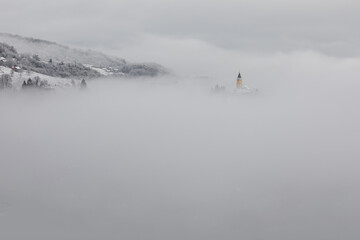 Winter in Croatia. Church. Fog. Snow