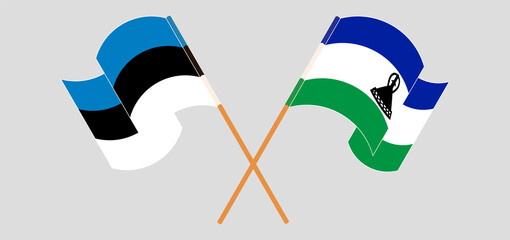 Crossed and waving flags of Estonia and Kingdom of Lesotho