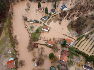 Aerial drone view of flooded villages, fields, farms and houses. Aftermath of devastating river flood and landslide. Catastrophic floods. Overflowing river, view from above.