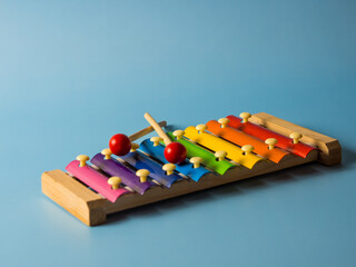 colorful educational xylophone toy on a blue background with copy space. Children's toy and musical...