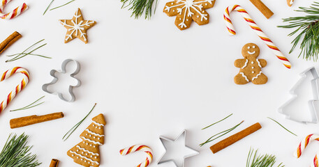 Christmas Banner. winter, new year composition. Christmas frame made of cinnamon sticks, candies, gingerbread on white background. Flat lay, top view, copy space