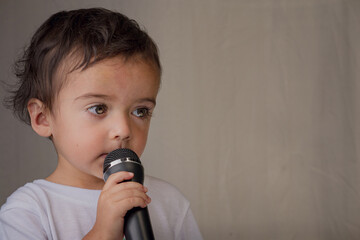 Little boy giving a speech with microphone