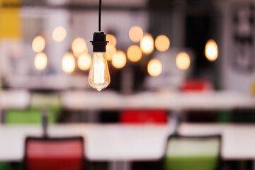 Decorative lightbulb hanging in a modern coworking office space.