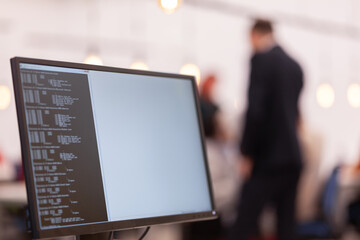 Desktop computer screen in an office. Abstract computer monitor with business people working in the...
