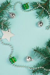 Festive Christmas background with fir branches, New Year decorations and New Year's decor on a light blue background. Copy space.