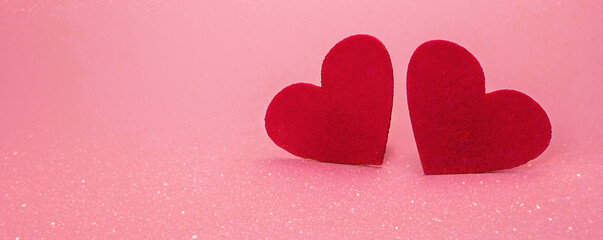 Valentine's day concept banner with two felt red hearts on pink background. Place for your text. Blurry bokeh. Festive background, love.Banner	