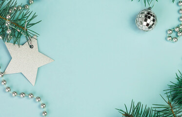 Festive Christmas background with fir branches, New Year decorations and New Year's decor on a light blue background. Copy space.