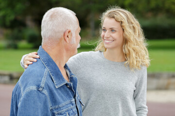 Obraz premium senior father with adult daughter outdoors