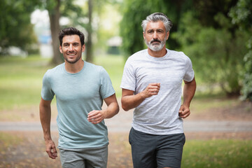 men jogging outdoor in nature - motion blur image panning