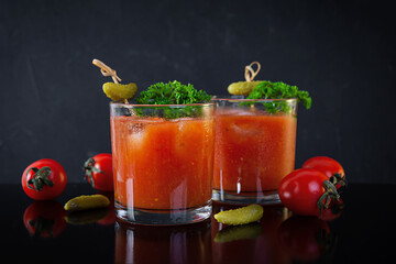 Alcohol cocktail Bloody Mary on dark background. Classic cocktail with tomato juice and vodka