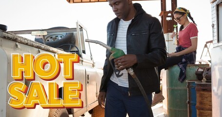 Hot sale text sign in front of man holding fuel pump by vehicle at gas station