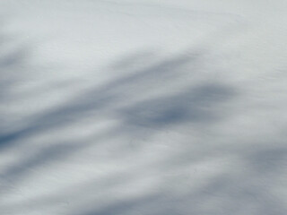 Fototapeta na wymiar Shadows and patterns on the surface of snow