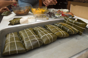 Traditional Venezuelan cuisine for the December festivities, Hallacas are a typical dish that is prepared as a family and represents ancestral traditions of a mixture of ingredients wrapped in leaves