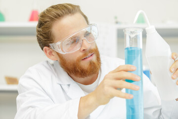 male researcher holding a test tube in the lab