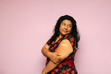Body positive overweight adult laina woman shows her arm recently vaccinated against Covid-19 in...