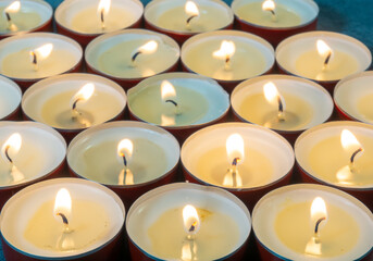 Lots of small lit candles. Dark mysterious atmosphere.  Flat round candles