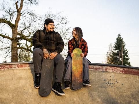 Indigenous father and non-binary skater and outdoors
