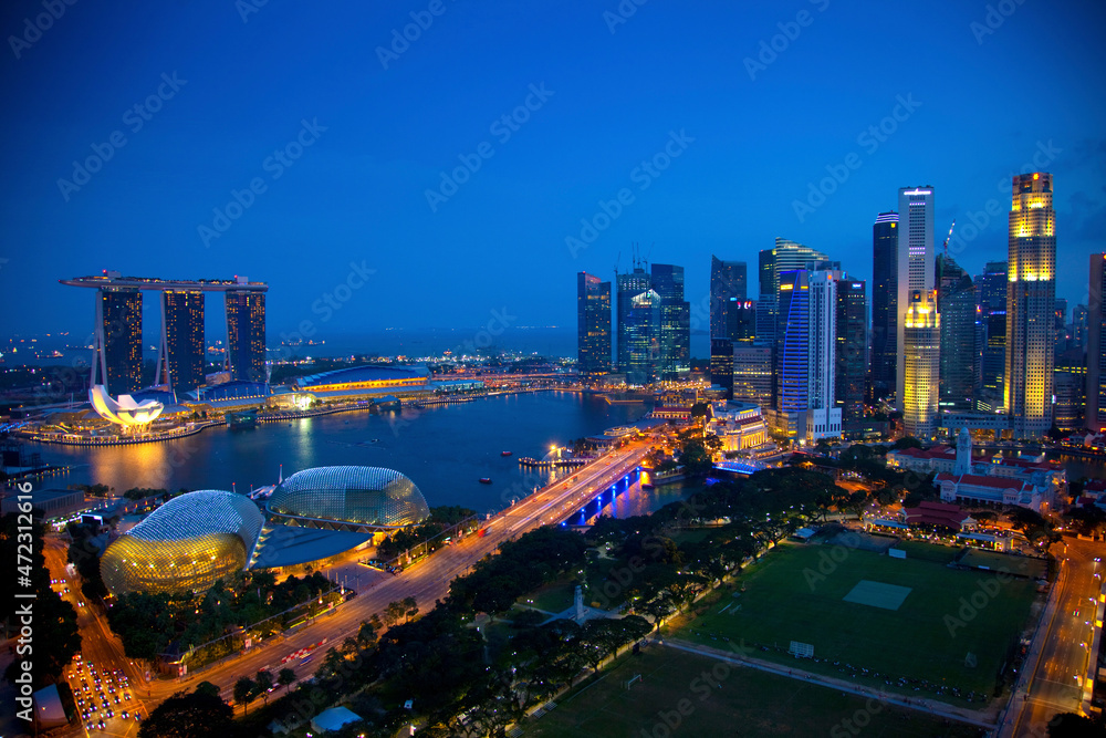 Poster Singapore. Overview of city at twilight.