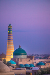 Central Asia, Uzbekistan, Khiva. Muslim minaret and mosque at sunset. - obrazy, fototapety, plakaty
