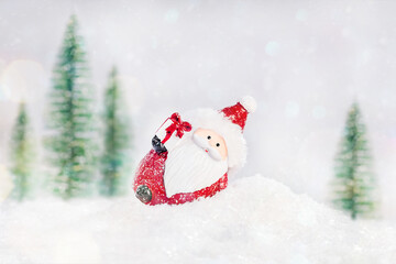 Greeting card, banner, poster.Santa lies in the snow on the background of Christmas trees.Winter background. Selective focus.Christmas composition.Christmas, winter, new year concept.