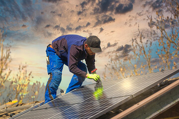 Installing solar photovoltaic panel system. Solar panel technician installing solar panels on roof....