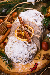 Christmas Holiday Background. Stollen, German Christmas Cake with Dried Fruits and Sliced Almonds Nuts. Selective focus.