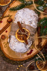 Christmas Holiday Background. Stollen, German Christmas Cake with Dried Fruits and Sliced Almonds Nuts. Selective focus.