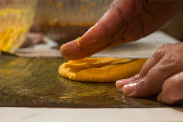 Traditional Venezuelan cuisine for the December festivities, hands preparing Hallacas. Typical dish...