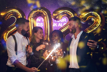 Happy group of friends celebrate New Year's Eve and taking selfie with a smartphone