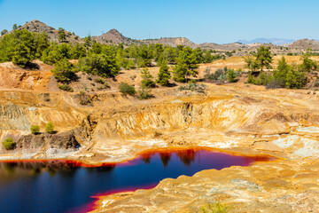 Heavy polluted toxic bloody colored Sha copper quarry lake, Nicosia, Cyprus