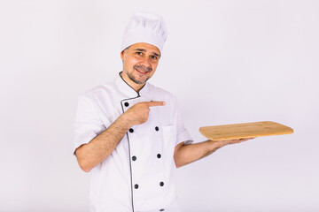 Chef cook wearing kitchen jacket and hat, holding a wooden tray, on white background