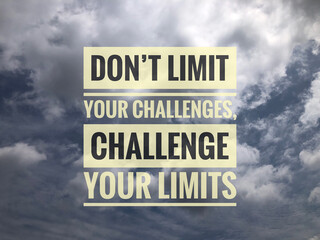 Motivational quote written with phrase DON'T LIMIT YOUR CHALLENGES, CHALLENGE YOUR LIMITS - obrazy, fototapety, plakaty