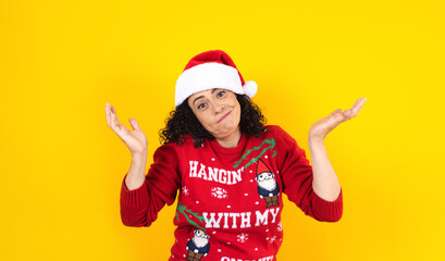 hispanic adult woman portrait with expression face in winter sweater on yellow background in Mexico Latin America