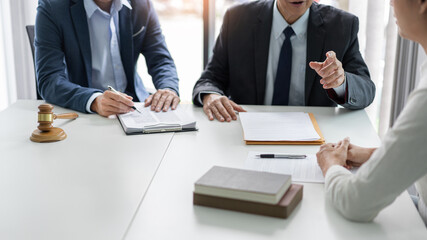 law concept the businessman, a man with the black suit, having a law consultation with the law officer, a man in deep blue suit and his assistant, a man in white shirt