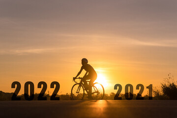 2022 New Year Concept with the silhouette of a bicycle rider