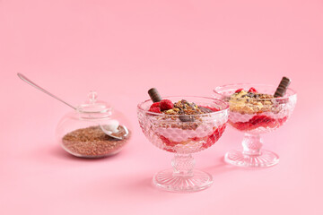 Tasty dessert with flax seeds and yoghurt in glasses on color background