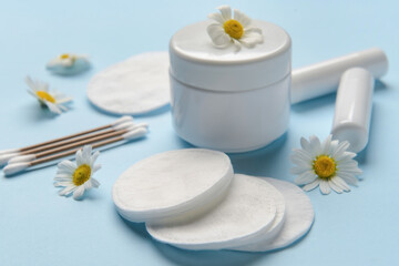 Care cosmetics, cotton buds, cotton pads and Chamomile flowers on color table, closeup © Pixel-Shot