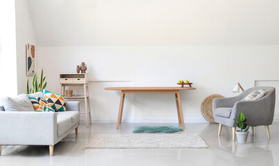 Wooden tables near light wall in modern living room