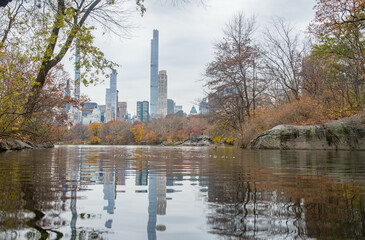 Nyc city skyline with lake reflection, shot from Central Park NYC, during fall season.