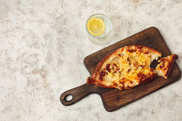 Tasty Ajarian khachapuri on table background, top view