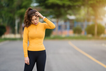 tired woman taking a rest after running or exercise in park