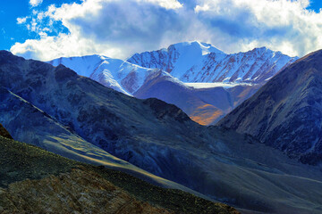 Rocky landscape of with ice peaks in background , Ladakh, Jammu and Kashmir, India