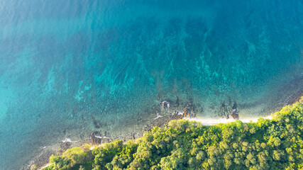 High aerial view of azure waters, white sandy beaches and rich forest nature on Koh Kood in Thailand.