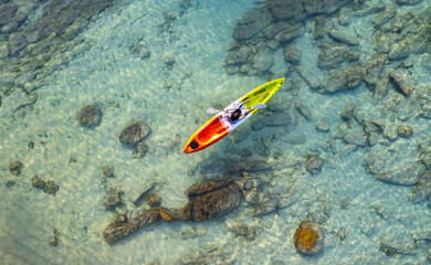 Fototapeta na wymiar Aerial view of a kayak in the blue sea .Woman kayaking She does water sports activities.
