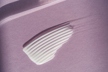 White cream texture on a purple background.