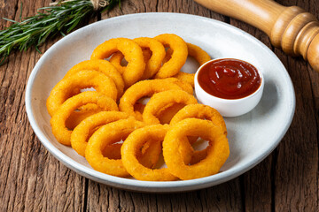 Crispy onion rings with ketchup.